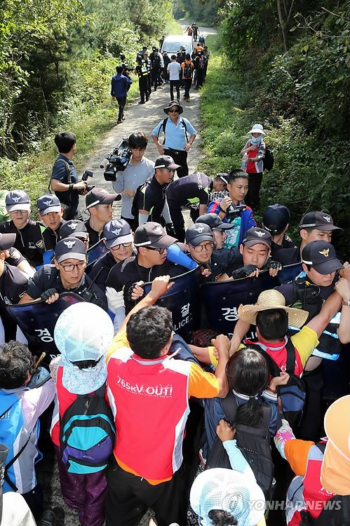 지난해 10월 경남 밀양시 단장면 고례리 765kV 송전탑 공사현장으로 가는 길목에서 공사에 반대하는 주민과 경찰이 몸싸움을 벌이고 있다.
